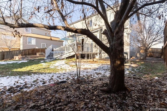 snowy yard with a deck