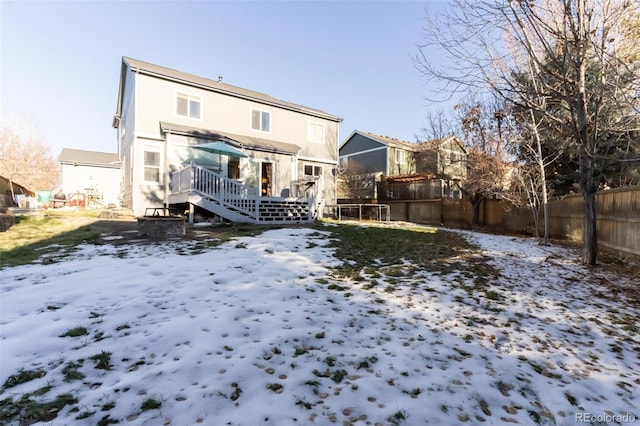 snow covered property featuring a wooden deck