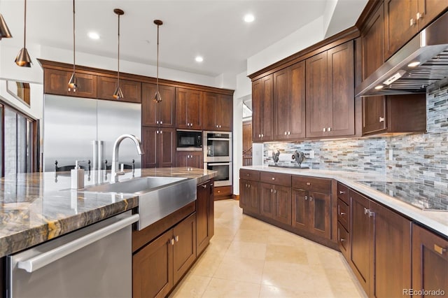 kitchen featuring pendant lighting, tasteful backsplash, sink, black appliances, and light stone countertops