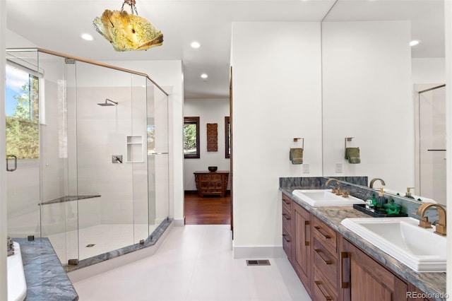 bathroom with vanity, tile patterned flooring, and a shower with shower door