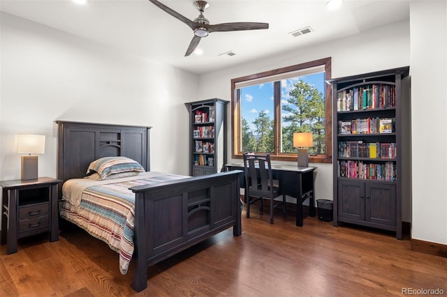 bedroom with dark hardwood / wood-style floors and ceiling fan