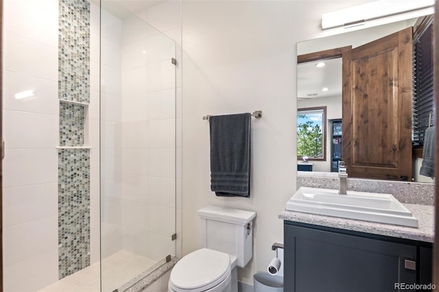 bathroom with vanity, toilet, and walk in shower