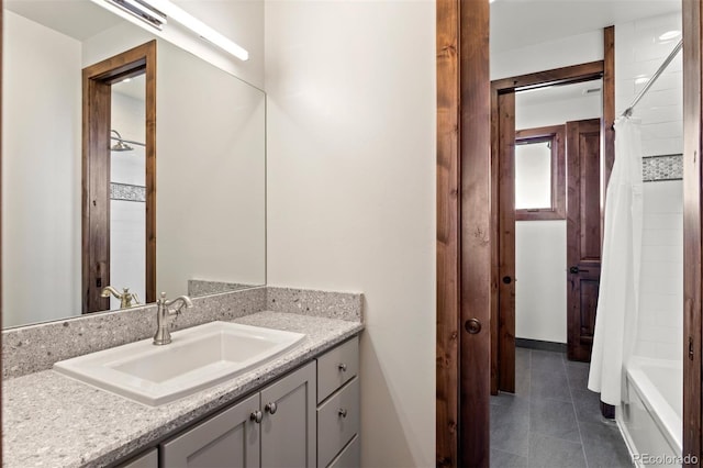 bathroom featuring vanity, tile patterned floors, and shower / bath combo with shower curtain