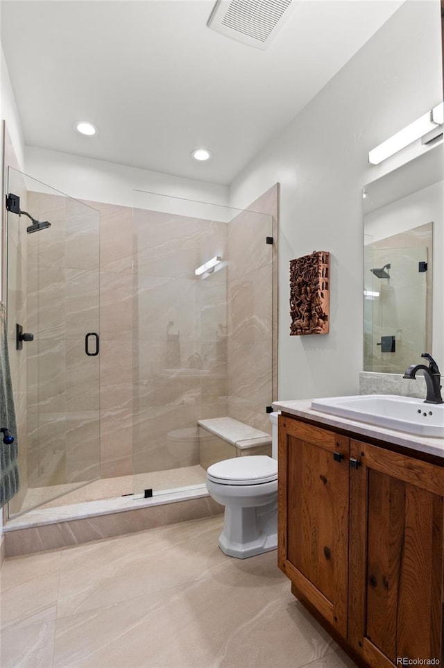 bathroom featuring vanity, toilet, and walk in shower