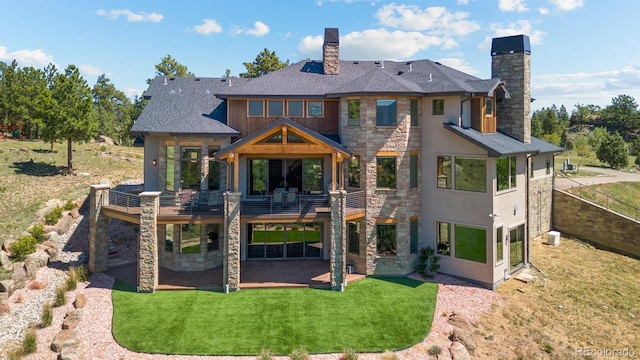 rear view of property featuring a yard and a patio area