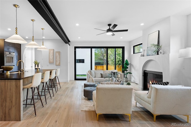 357 S Franklin St, Denver, CO 80209 - living room featuring a glass covered fireplace, ceiling fan, light wood-style flooring, recessed lighting, and baseboards