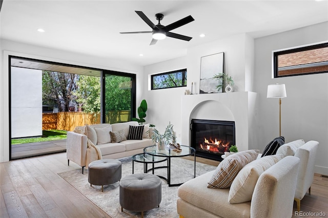357 S Franklin St, Denver, CO 80209 - living room featuring wood finished floors, a glass covered fireplace, recessed lighting, and a ceiling fan