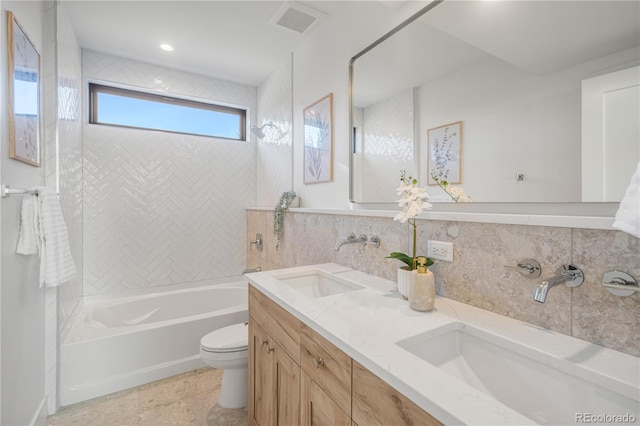 357 S Franklin St, Denver, CO 80209 - bathroom featuring toilet, bathing tub / shower combination, double vanity, and backsplash