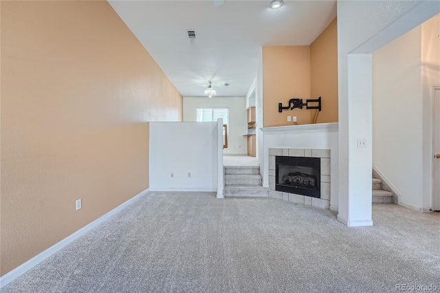 unfurnished living room with a fireplace and light colored carpet