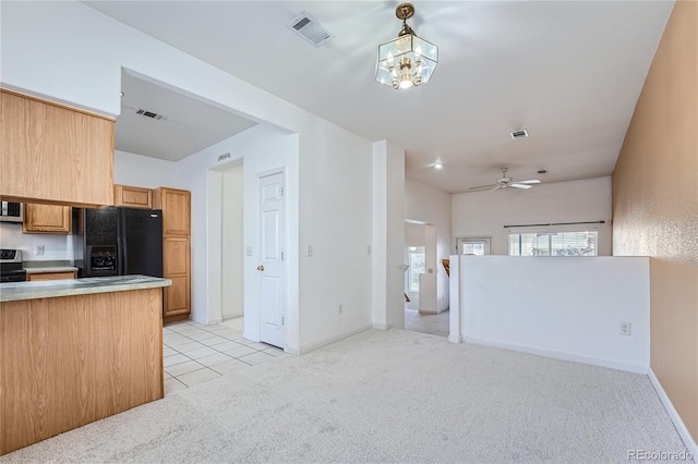 kitchen with ceiling fan with notable chandelier, black fridge with ice dispenser, light carpet, range, and decorative light fixtures