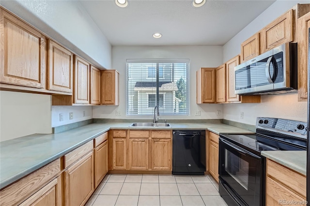 kitchen featuring black appliances, sink, light brown cabinetry, and light tile patterned floors