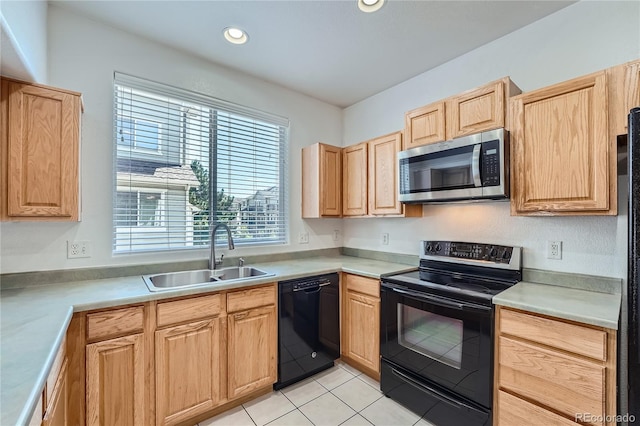 kitchen featuring black appliances, sink, light brown cabinets, and light tile patterned floors