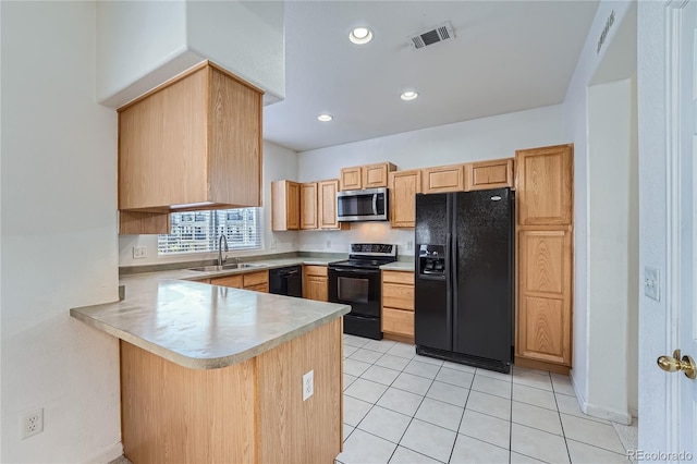 kitchen with light brown cabinetry, light tile patterned floors, sink, black appliances, and kitchen peninsula