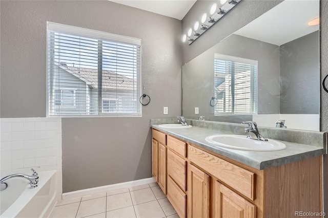 bathroom with a bathing tub, tile patterned floors, and dual vanity