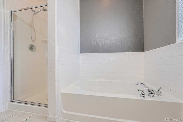 bathroom with plus walk in shower and tile patterned flooring