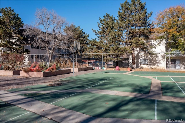 view of home's community featuring basketball hoop