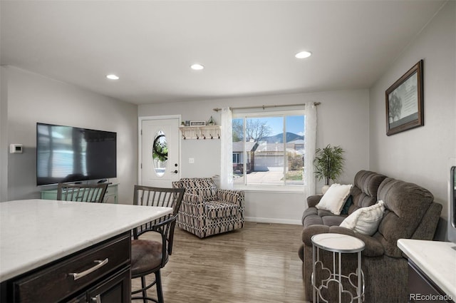 living area featuring wood finished floors, recessed lighting, and baseboards