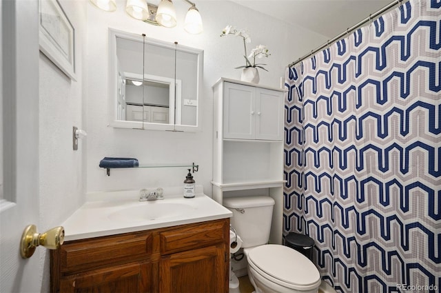 bathroom with toilet, vanity, and a shower with curtain