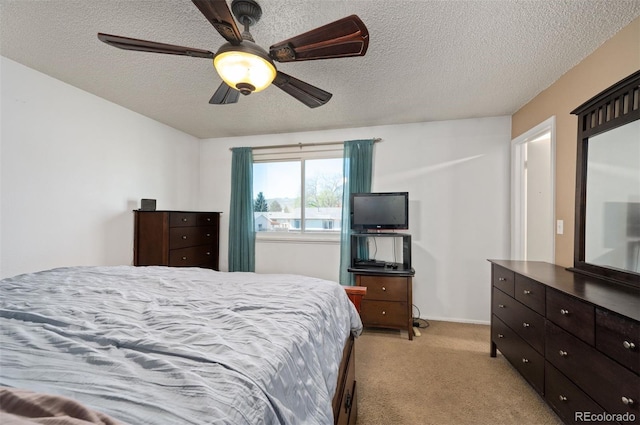 bedroom with light colored carpet, a textured ceiling, and a ceiling fan