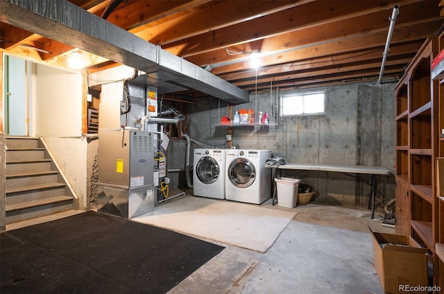 basement featuring separate washer and dryer, heating unit, and stairway