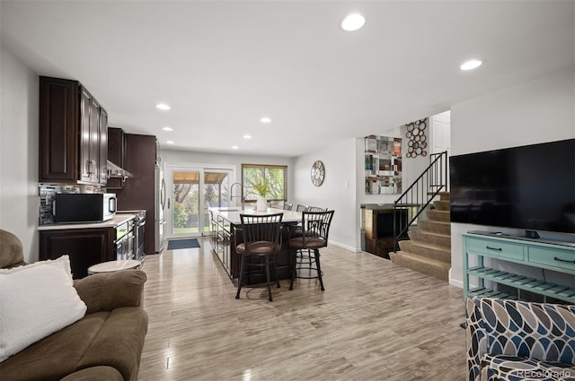 4360 S Braun Ct, Morrison, CO 80465 - living room with stairs, light wood-type flooring, recessed lighting, and baseboards