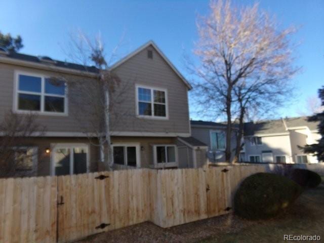 back of property featuring a fenced front yard