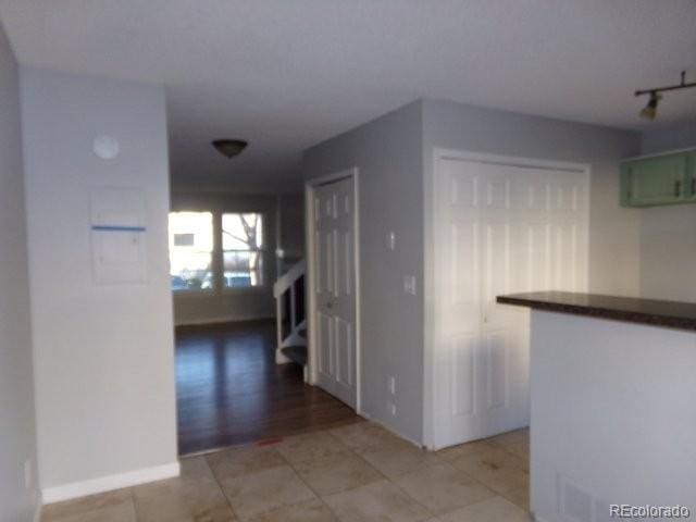 hall featuring light tile patterned flooring