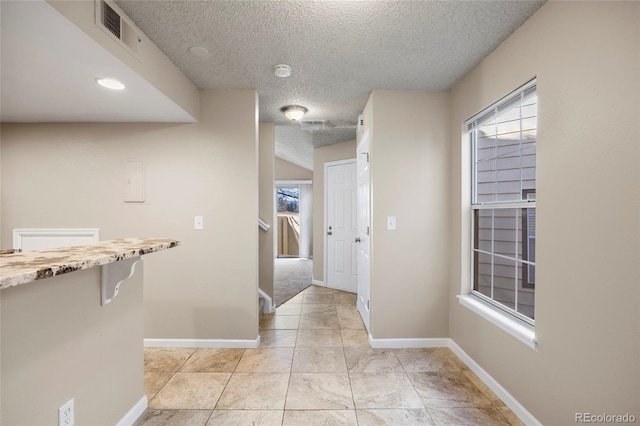 corridor with a textured ceiling