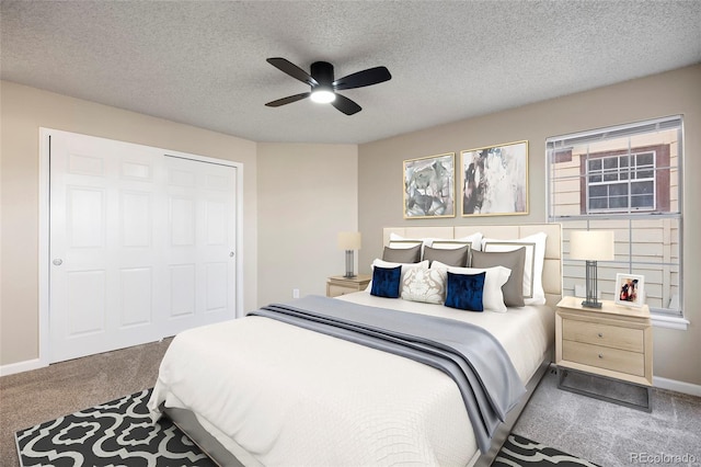 bedroom with a textured ceiling, ceiling fan, carpet flooring, and a closet