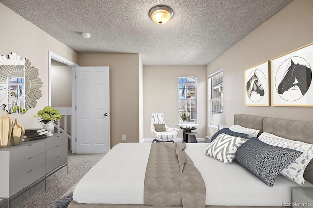 bedroom with carpet and a textured ceiling