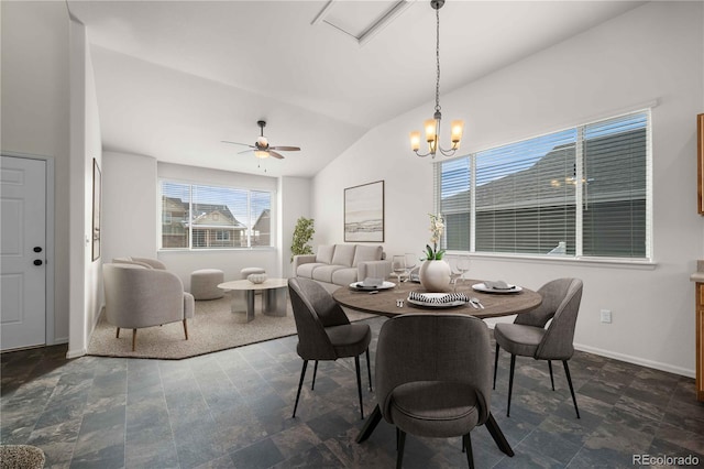 dining room with ceiling fan with notable chandelier and lofted ceiling