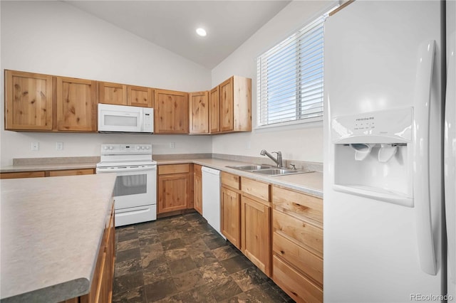 kitchen featuring sink, white appliances, and lofted ceiling