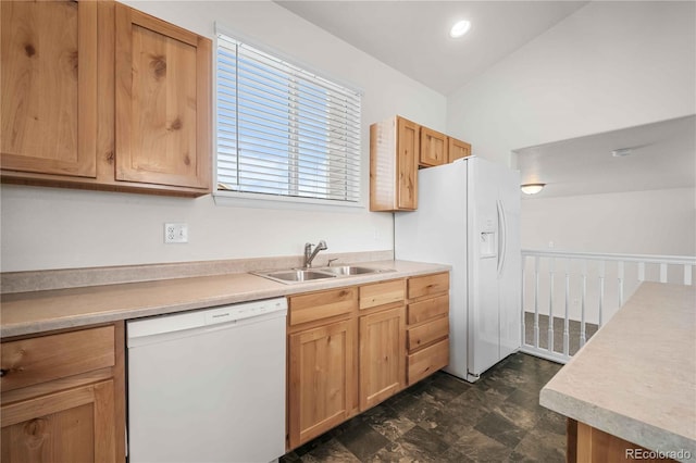 kitchen with sink, white appliances, and vaulted ceiling