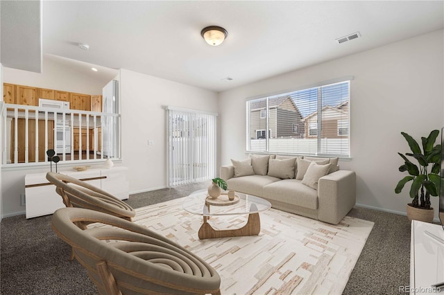 carpeted living room featuring vaulted ceiling