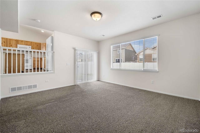 empty room with vaulted ceiling and carpet flooring