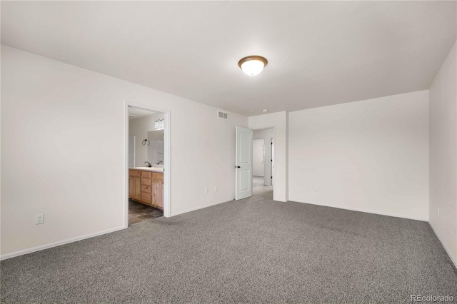 carpeted empty room featuring sink