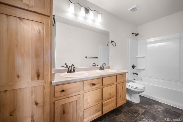 full bathroom with toilet, vanity, and shower / washtub combination