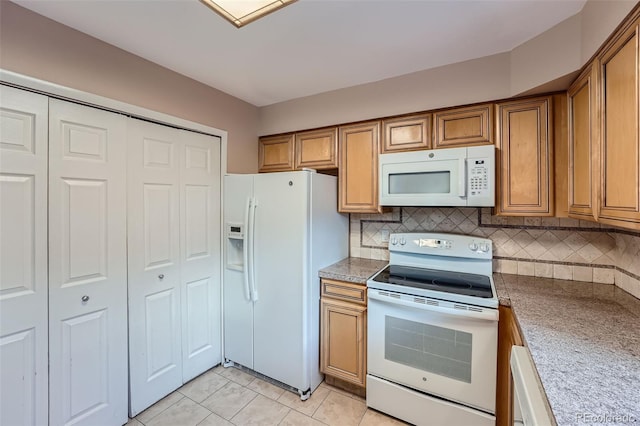 kitchen featuring backsplash, white appliances, and light tile patterned floors