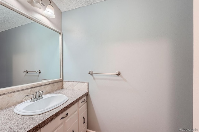 bathroom featuring vanity, decorative backsplash, and a textured ceiling