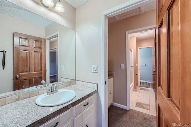 bathroom with vanity, a textured ceiling, and tile patterned floors