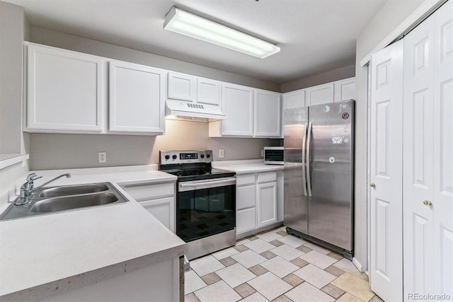 kitchen featuring light countertops, a sink, under cabinet range hood, and stainless steel appliances