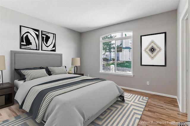 2575 S Syracuse Way Unit 101, Denver, CO 80231 - bedroom featuring baseboards and wood finished floors