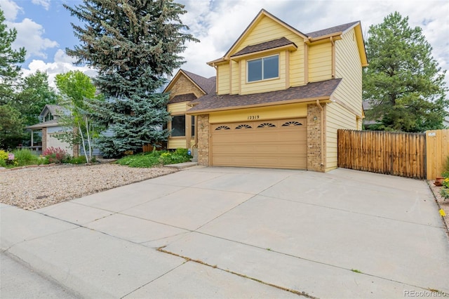 12319 W Burgundy Ave, Littleton, CO 80127 - view of front facade featuring brick siding, an attached garage, concrete driveway, and roof with shingles
