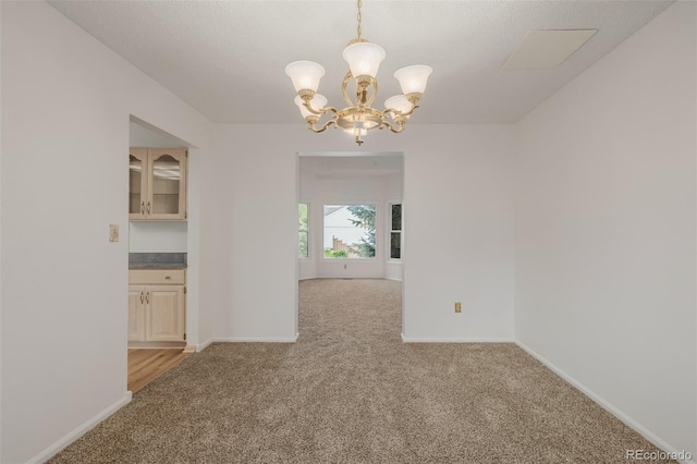 12319 W Burgundy Ave, Littleton, CO 80127 - unfurnished room featuring light carpet and a chandelier