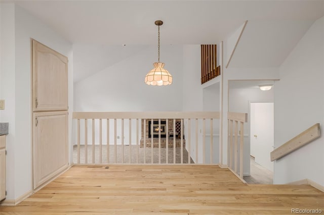 12319 W Burgundy Ave, Littleton, CO 80127 - corridor featuring light wood finished floors, an upstairs landing, and high vaulted ceiling