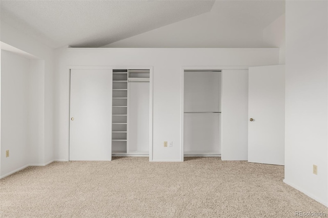 12319 W Burgundy Ave, Littleton, CO 80127 - unfurnished bedroom with multiple closets, carpet, and lofted ceiling