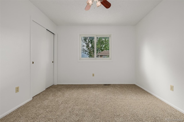 12319 W Burgundy Ave, Littleton, CO 80127 - unfurnished bedroom featuring carpet flooring, a closet, a ceiling fan, and a textured ceiling
