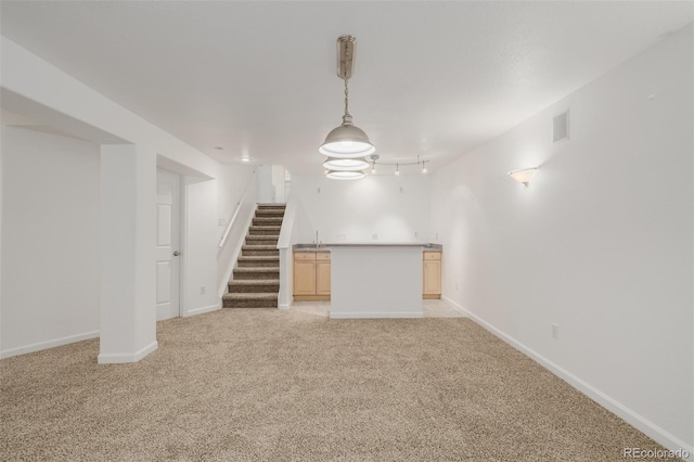 12319 W Burgundy Ave, Littleton, CO 80127 - unfurnished living room featuring light colored carpet, stairway, and track lighting
