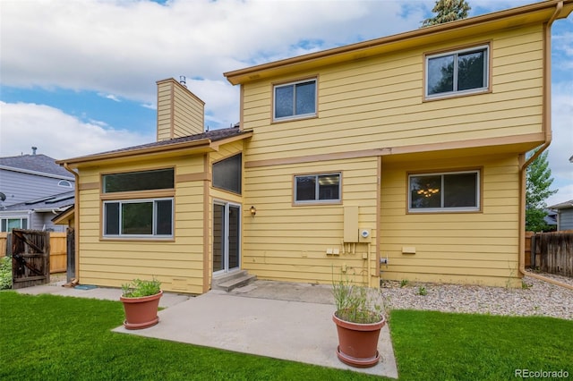 12319 W Burgundy Ave, Littleton, CO 80127 - rear view of property featuring a patio, entry steps, a chimney, and a gate