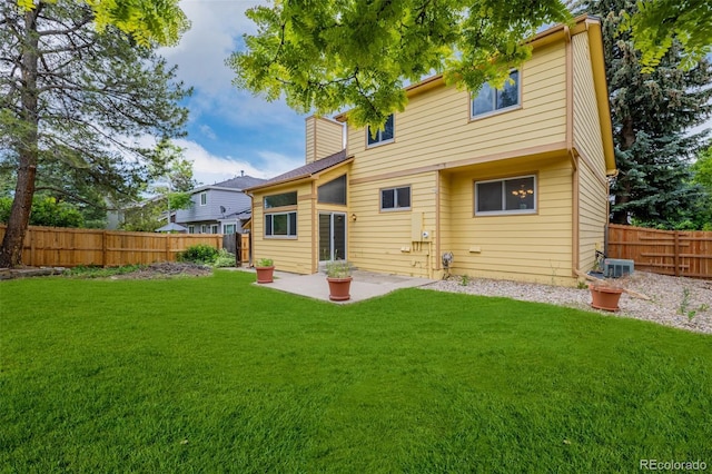 12319 W Burgundy Ave, Littleton, CO 80127 - back of property with a chimney, a fenced backyard, and a patio area